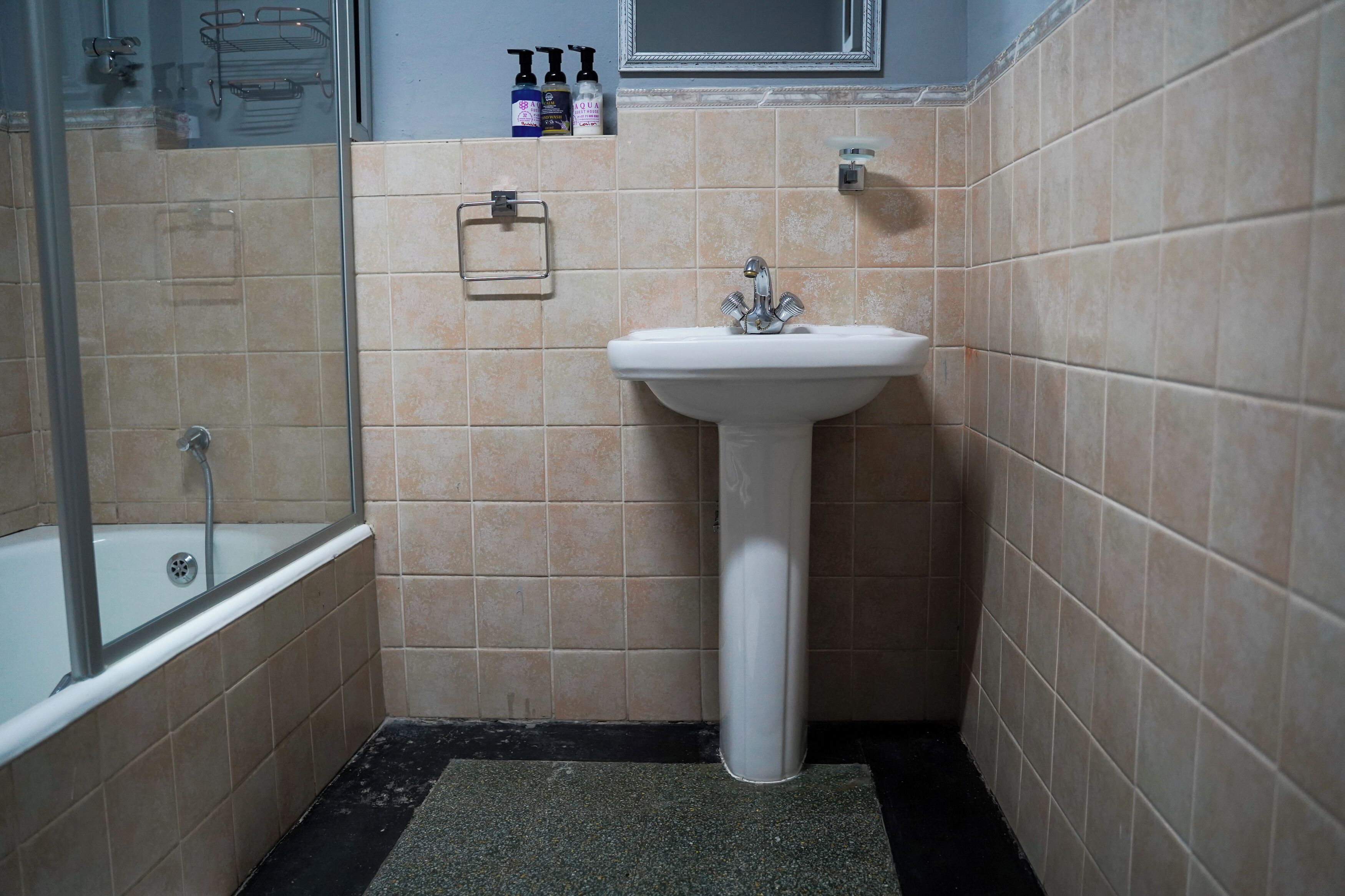 A bathroom with a bathtub, a sink, and a shower.