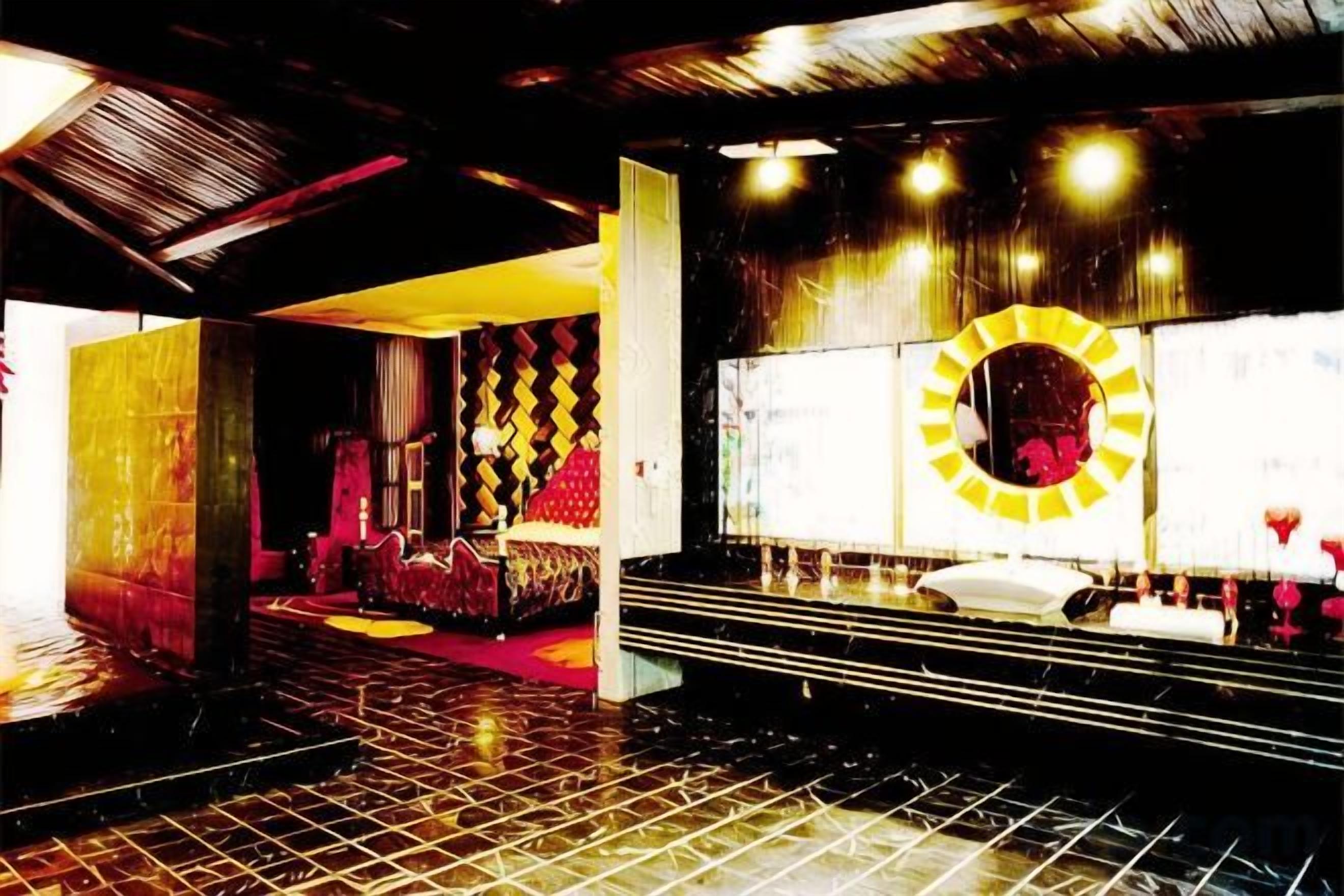 A hotel lobby with a check-in counter, seating area, and a large circular window.