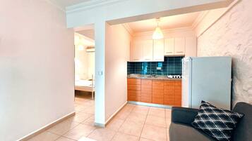 Full-sized fridge, stovetop, cookware/dishes/utensils