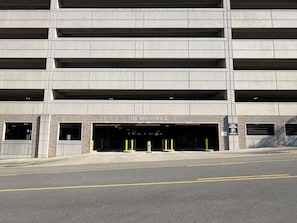 A multi-level parking garage entrance with a sign reading '155 BRUNSWICK T.' - Leisure at The Cove Riverwalk Villas (Wilmington)
