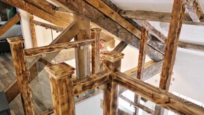 A wooden staircase with a rustic design, leading to an upper floor. - Blissful Bradford Apartment - City Center Gem (Bradford)