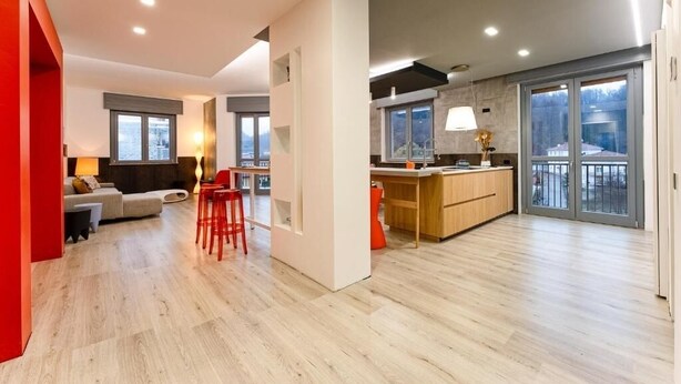 A modern apartment with a kitchen, dining area, and living room. - Camere CA + Millo - Camera 3 (Crevacuore)