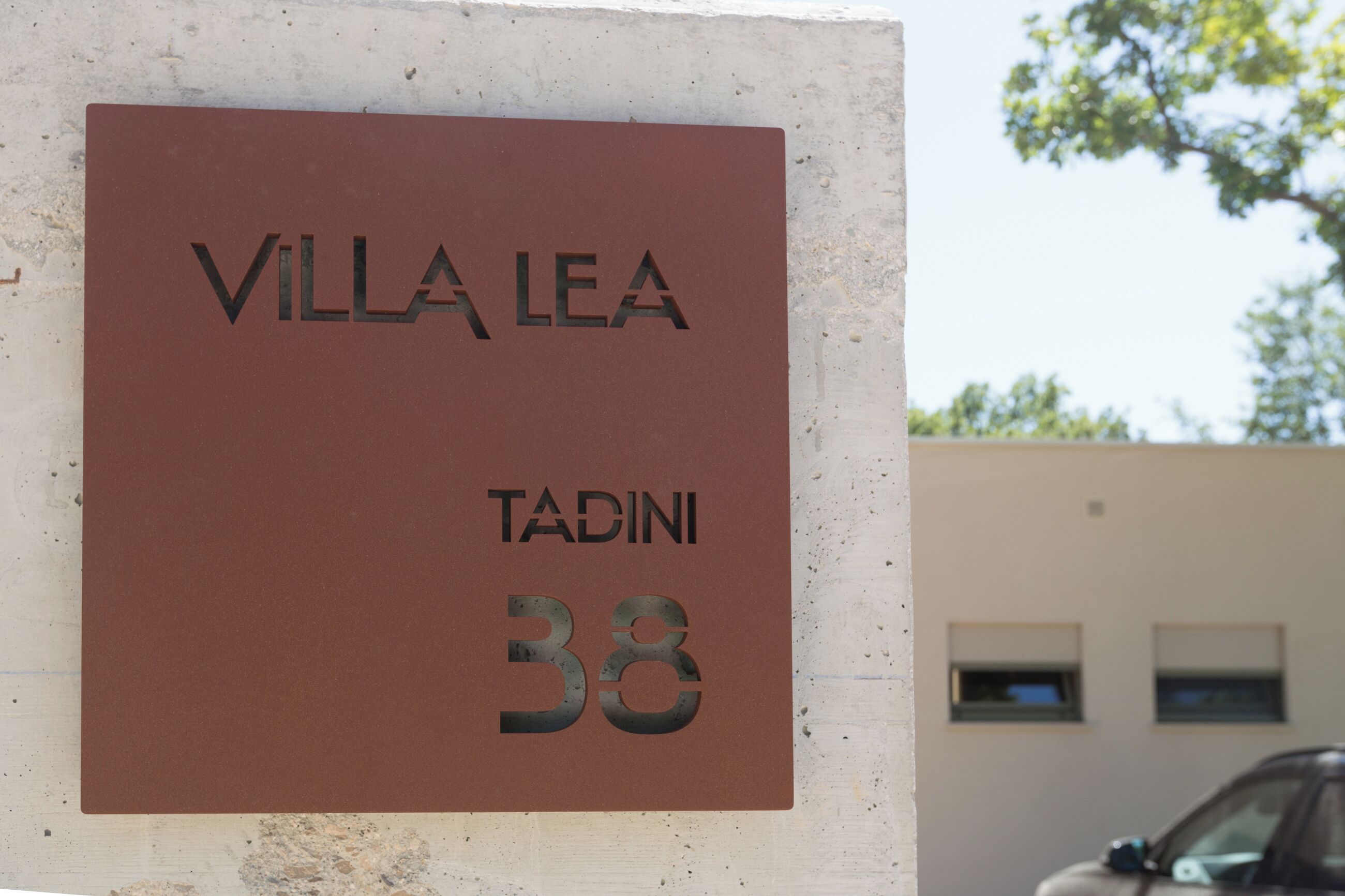 A sign with the text "VILLA LEA" and "TADINI 38".