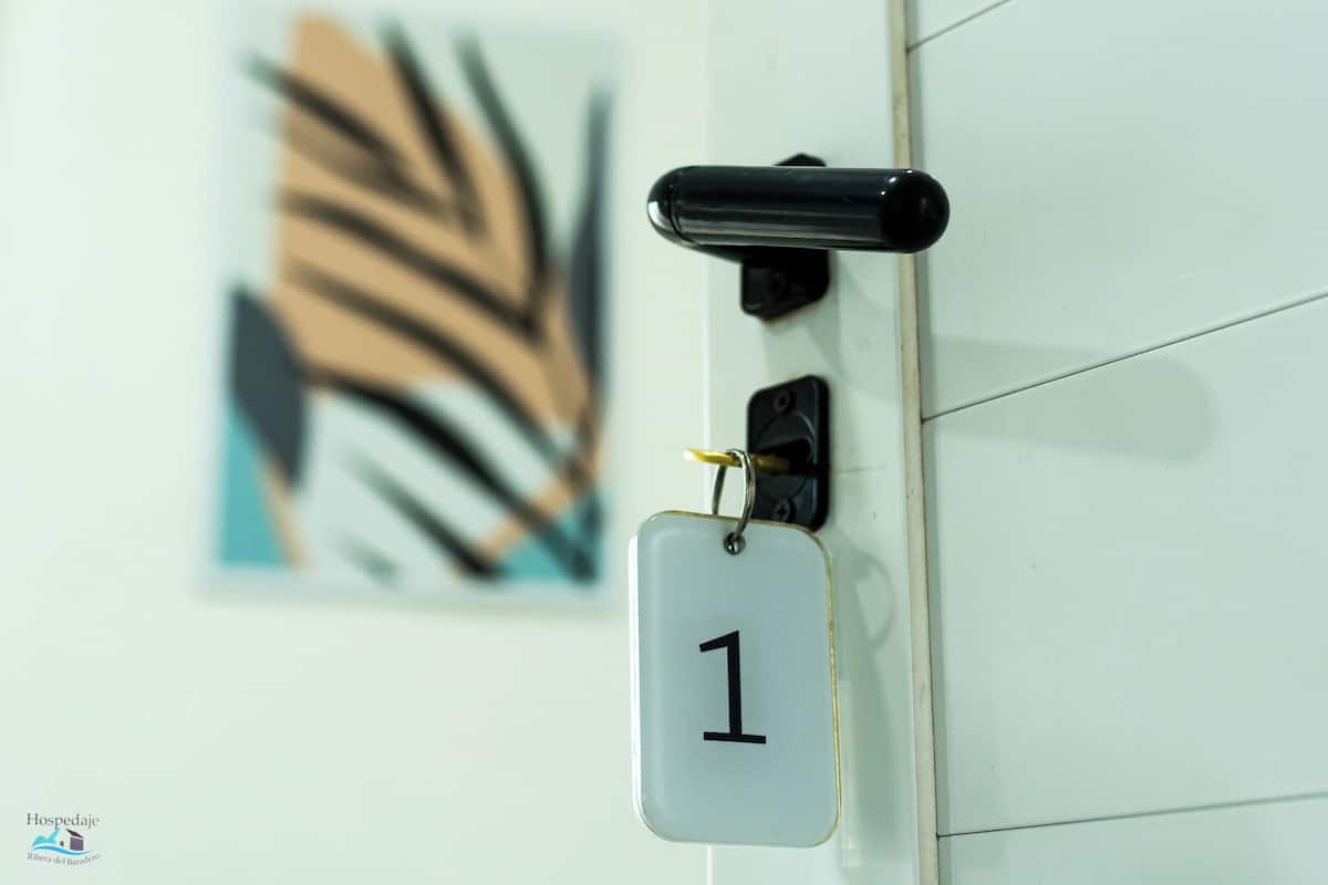 A door with a number plate labeled '1', a black handle, and a keyhole.