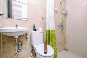 Une salle de bain avec un lavabo, des toilettes et une douche.