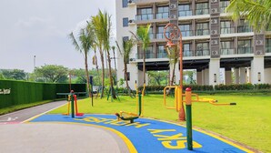 A playground with exercise equipment and a blue bike lane. - Good Designed And Restful Studio Sky House Bsd Apartment (Pagedangan)