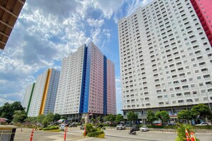 Un edificio de varios pisos con un diseño arquitectónico moderno, que presenta una llamativa franja vertical de color en una de las construcciones.