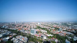 An aerial view of a cityscape with dense urban development, including high-rise buildings and a mix of residential and commercial structures. - Simple And Comfortable Living 1Br At The City Square Apartment (Surabaya)