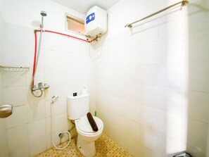 Bathroom features a toilet, shower, and water heater.