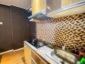 Deluxe Apartment | Private kitchen | Fridge, stovetop, dining tables - Cozy Designed 2Br At Tamansari Panoramic Apartment (Bandung)