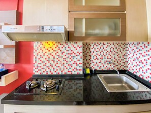 Full-sized fridge, stovetop - Serene Studio Room At 5Th Floor Suites @Metro Apartment (Bandung)