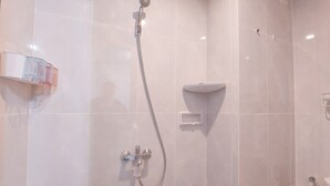 A modern bathroom with a shower, a soap dish, and a hand dryer. - Homey And Cozy Studio At Serpong Garden Apartment (Cisauk)