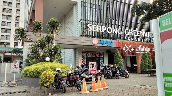 A modern building with a sign for 'Serpong Greenview Apartment' and 'Ageru Art Studio'. - Good Deal And Comfortable Studio Serpong Greenview Apartment (South Tangerang)