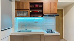 Apartment | Private kitchen | Fridge, stovetop, rice cooker, dining table - Comfort Look 2Br At Meikarta Apartment (Cikarang)