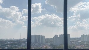 A cityscape with high-rise buildings and a clear sky. - The Elite Enclave Studio At Beverly Dago Apartment (Bandung)