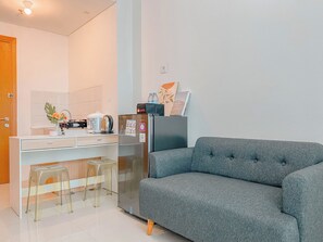 Cozy living space with a kitchenette, dining table, and sofa.