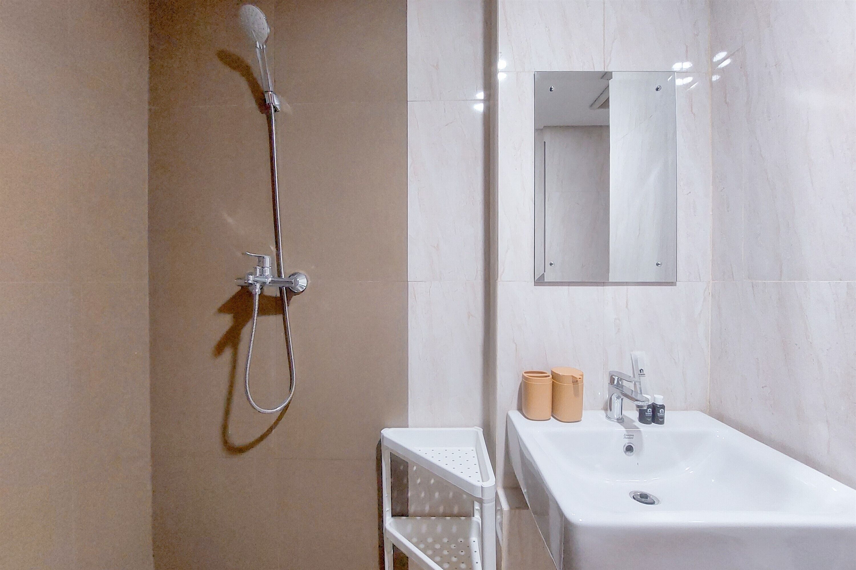 A modern bathroom with a shower, sink, and mirror.