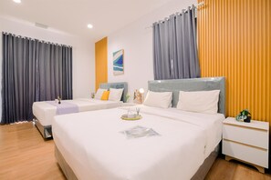 A hotel room with two beds, a nightstand, and a wall-mounted shelf. - Vimala Hills Villa Gadog Puncak 3Br For 12 Pax (Ciawi)
