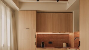 Une cuisine moderne avec des meubles en bois, une table ronde et une chaise.