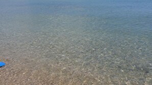 A clear beach with calm water and a distant buoy. - Apartment Eucaliptus sea View (Avola)