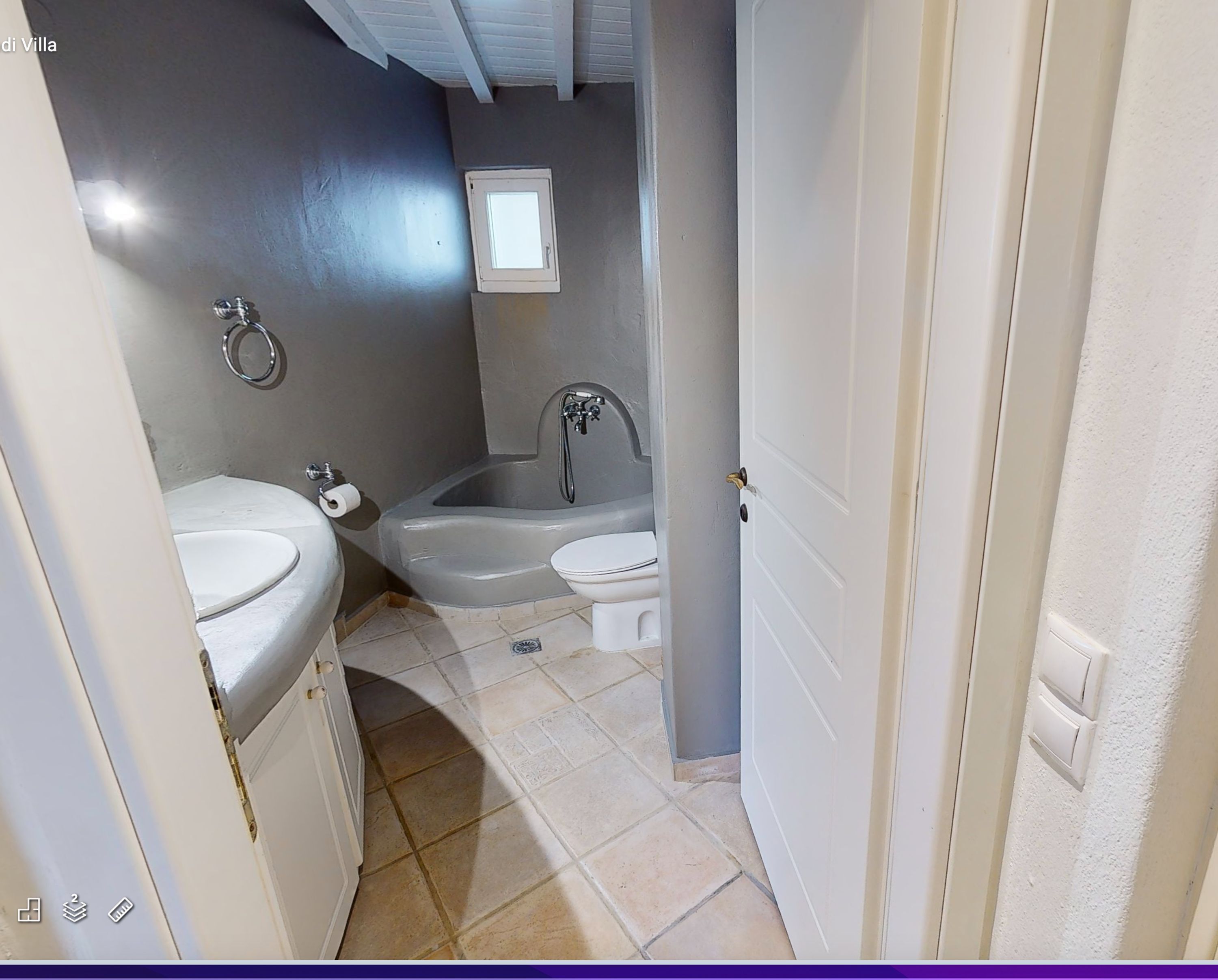 A bathroom with a toilet, sink, and bathtub.