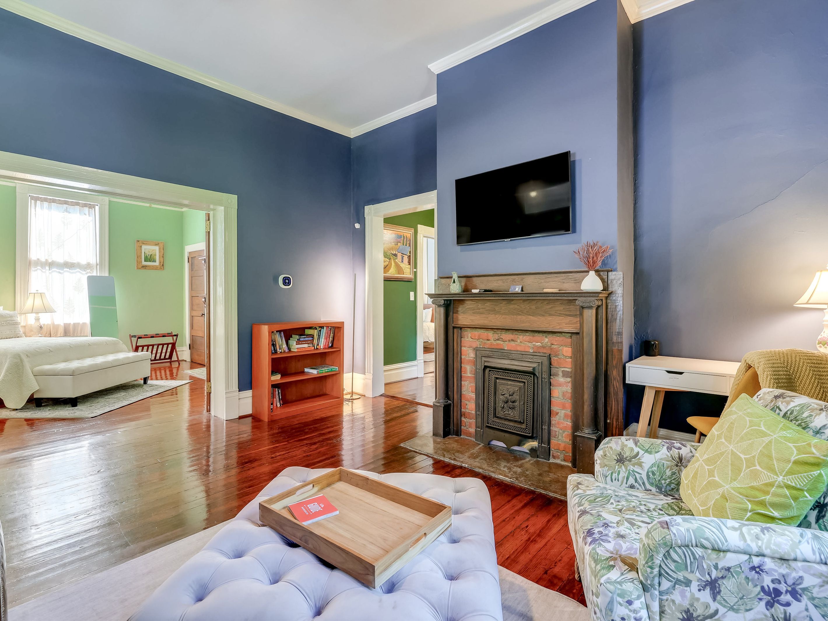 A workspace sits next to the fireplace, and a cozy armchair invites you to curl up with a book.