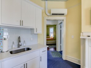 A kitchen with white cabinets, a stainless steel sink, and a white countertop. - Sand Hills: Medical District, Historic Summerville (Augusta)