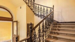 A staircase with ornate metal railings and wooden steps. - IMCT - Dizsu's Place Budapest (Budapest)