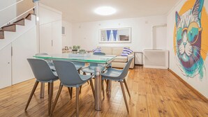 A modern kitchen with a dining table, chairs, and a staircase. - IMCT - Beautiful Home at Basilica 1 (Budapest)