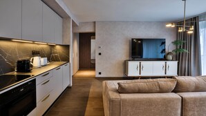 A modern kitchen with a built-in oven, a coffee maker, and a microwave.