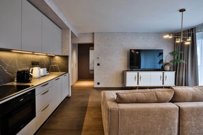 A modern kitchen with a built-in oven, a coffee maker, and a microwave.