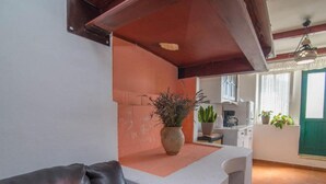 A kitchen with a white countertop, a brown leather chair, and a potted plant. - Apartments Bonic - Two Bedroom Apartment (Veli Losinj)