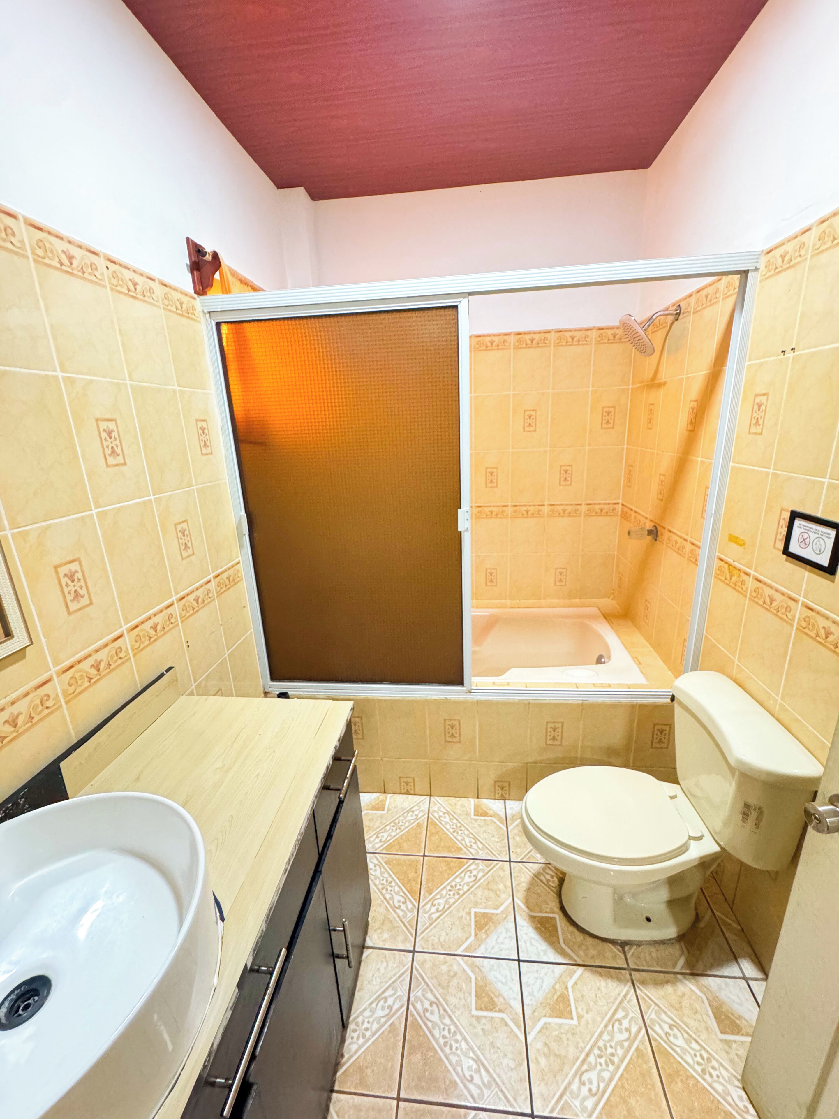 A bathroom with a bathtub, toilet, and sink.