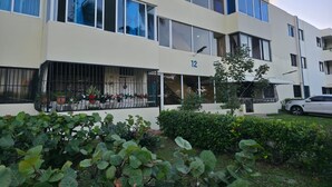 Um edifício com vários andares, grandes janelas e sacadas.