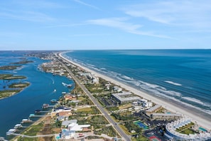 An aerial view of a coastal area with a beach, marina, and buildings. - Coquina A104 Ground floor walk out unit. Direct Ocean View! (Saint Augustine Beach Florida)