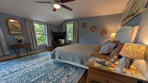A bedroom with a bed, a nightstand, a desk, a chair, a ceiling fan, and a window. - Robin's Bluff- Classic 3-bedroom in beautiful Whitefish Bay, convenient location (Whitefish Bay)