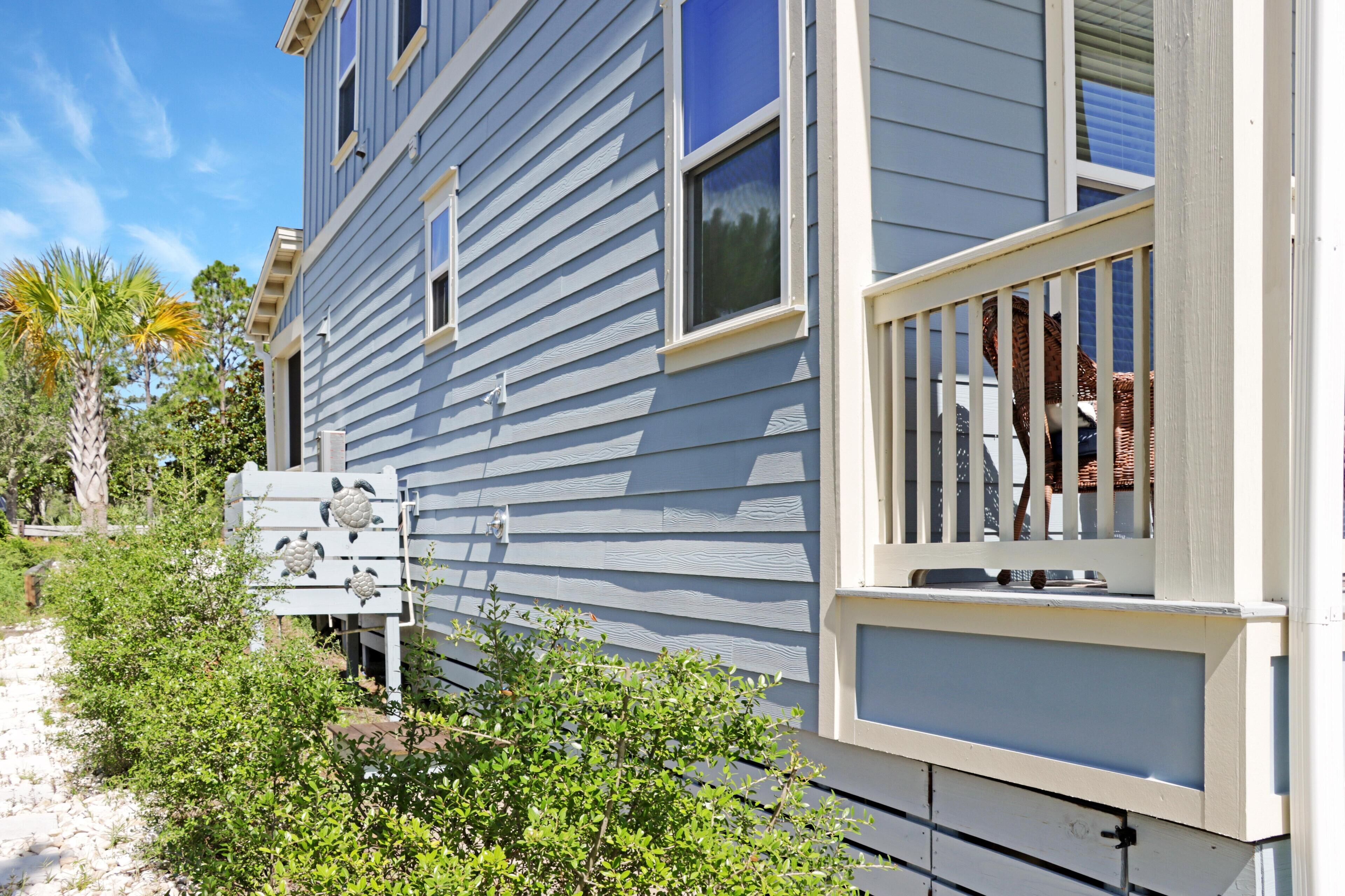 A two-story house with a balcony and a small porch.