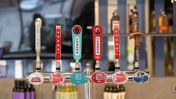 A tap system with various beer labels including brands like Stella Artois, Mahou, Camden Pale Ale, and Hells.