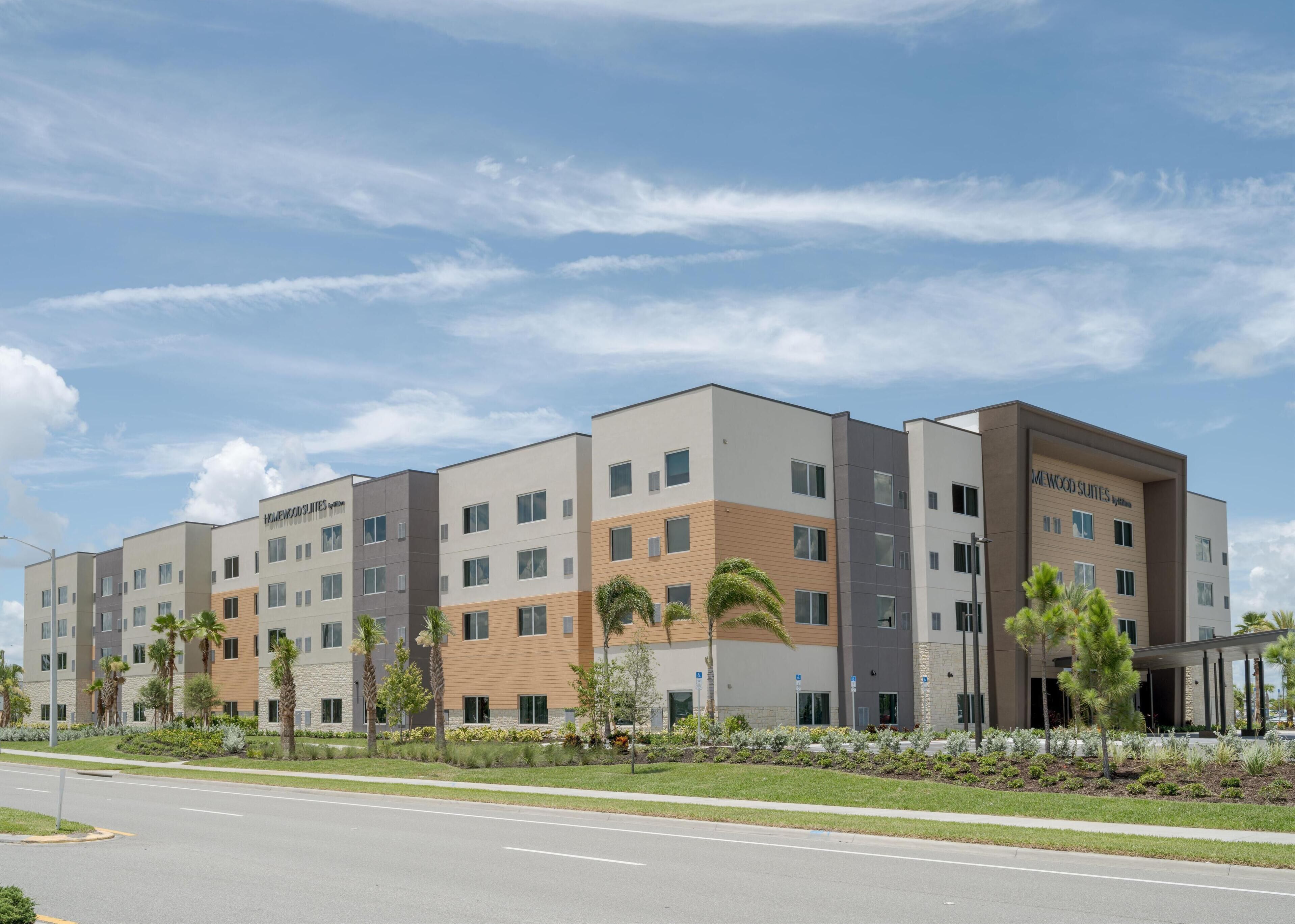 A modern hotel with multiple floors, a flat roof, and a well-maintained exterior.