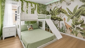 A child's bedroom with a bunk bed, a slide, and a jungle-themed wall mural. - Amazing Windsor Island 7BR/Pool/Spa/Closeto Disney (Davenport)