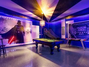 A pool table in a room with a Darth Vader statue, a neon light, and a wall with a space-themed mural. - Amazing Windsor Island 7BR/Pool/Spa/closeTo Disney (Davenport)