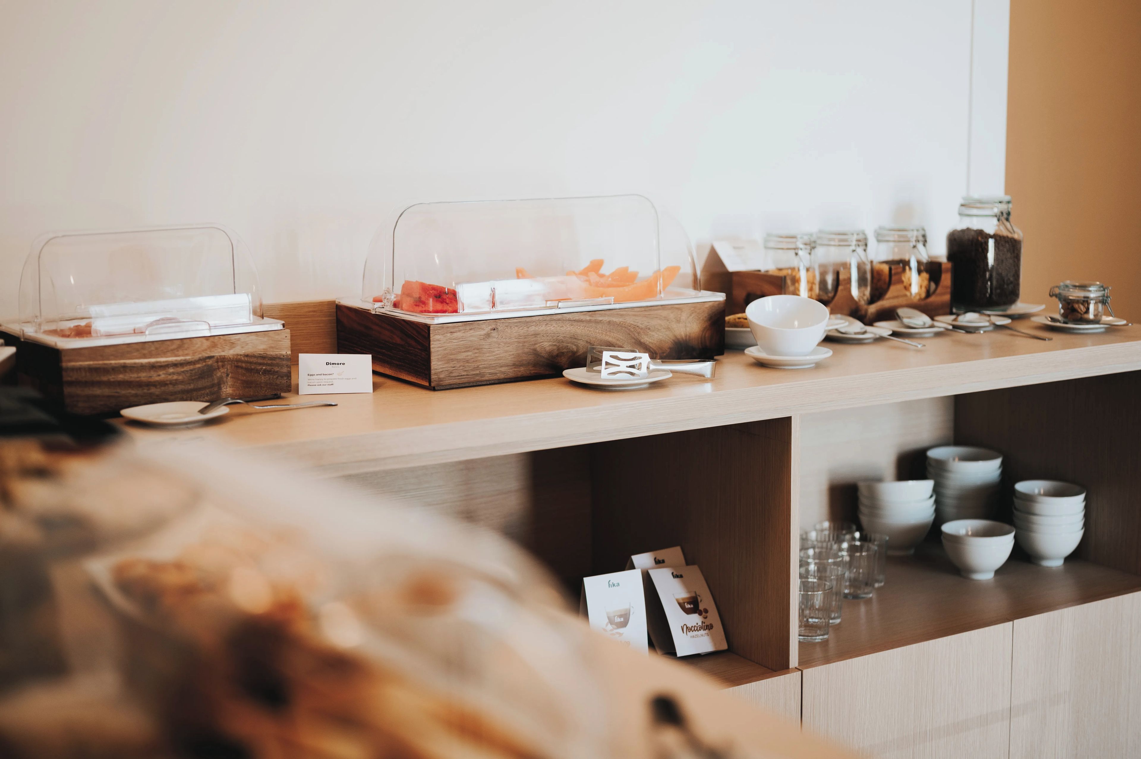 A buffet setup with various food items and condiments.
