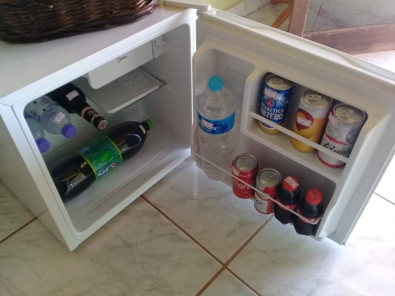 A refrigerator stocked with beverages and condiments.