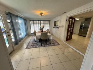 Enjoy meals with family and friends in this dining area, featuring a large table and six chairs.