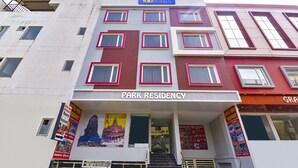 A multi-story hotel with a sign reading "Park Residency." - Fabexpress Park Residency I (Haridwar)