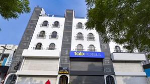 A hotel with a modern facade, multiple balconies, and a prominent 'Tab Hotels' sign. - Treebo Bella Vista (Udaipur)