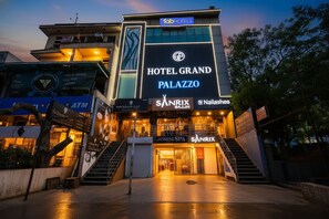 Un hôtel moderne avec une enseigne bien visible indiquant « Hôtel Grand Palazzo ».