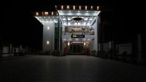 A modern hotel entrance with a prominent sign, a covered walkway, and potted plants. - Fabhotel Jb Square Resort (Faizabad)