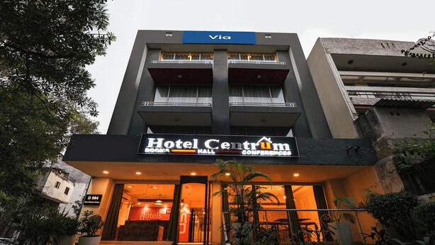 A hotel with a 'Hotel Centrum' sign, a 'Via' sign above, and a staircase leading to the entrance. - FabHotel La Serene NFC (New Delhi)