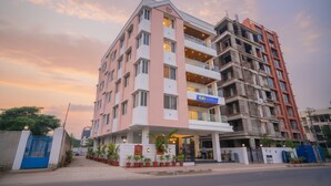 A multi-story hotel with a modern facade, balconies, and a sign for 'Tab Hotels'. - Fabhotel Prime Athiti Delight Stay (Pune)